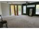 Open living room with sliding glass doors, ceiling fan, and accent wall at 1420 Lake Shadow Cir # 9207, Maitland, FL 32751