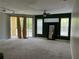 Open living room with sliding glass doors, ceiling fan, and accent wall at 1420 Lake Shadow Cir # 9207, Maitland, FL 32751