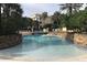 Lovely community pool with umbrellas and lounge chairs, surrounded by trees and landscaping at 1420 Lake Shadow Cir # 9207, Maitland, FL 32751