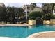 Inviting community pool with lounge chairs, landscaping, and a relaxing waterfall feature at 1420 Lake Shadow Cir # 9207, Maitland, FL 32751