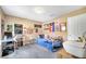 Comfortable bedroom featuring gray carpeting and decorated with colorful posters, desk and comfortable daybed at 14883 Golden Sunburst Ave, Orlando, FL 32827
