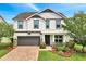 Charming two-story home with a well-manicured lawn and a two-car garage at 14883 Golden Sunburst Ave, Orlando, FL 32827