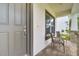 Inviting covered front porch with seating area, ideal for enjoying morning coffee or greeting guests at 14883 Golden Sunburst Ave, Orlando, FL 32827