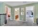 Upstairs hallway featuring access to a bathroom, bedroom, and playroom, all painted in pastel hues at 14883 Golden Sunburst Ave, Orlando, FL 32827