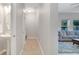 Hallway with half bath access and view to the living room at 14883 Golden Sunburst Ave, Orlando, FL 32827