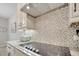 Close-up of kitchen with granite countertops, modern backsplash, and stainless steel appliances at 14883 Golden Sunburst Ave, Orlando, FL 32827