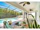Relaxing screened-in lanai with comfortable seating and view of the pool at 14883 Golden Sunburst Ave, Orlando, FL 32827
