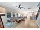 Open-concept living room with ample seating and seamless transition to the kitchen and dining area at 14883 Golden Sunburst Ave, Orlando, FL 32827