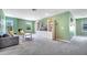 Spacious living room features plush gray carpeting, a comfortable sofa, and built-in shelving for storage and decor at 14883 Golden Sunburst Ave, Orlando, FL 32827