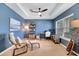 Bright living room with accent wall, tray ceiling, natural light, and a cozy seating arrangement at 14883 Golden Sunburst Ave, Orlando, FL 32827
