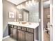 Bright main bathroom with double vanity, plenty of counter space, and a separate toilet room at 14883 Golden Sunburst Ave, Orlando, FL 32827
