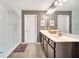 Main bathroom featuring a double sink vanity, framed mirrors, and a glass-enclosed shower at 14883 Golden Sunburst Ave, Orlando, FL 32827