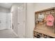 Mudroom featuring a built-in bench with shoe storage underneath and hooks for hanging bags at 14883 Golden Sunburst Ave, Orlando, FL 32827