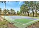 Community pickleball court with trees and landscaping at 14883 Golden Sunburst Ave, Orlando, FL 32827