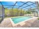 Inviting backyard pool featuring screened enclosure and brick paver patio at 14883 Golden Sunburst Ave, Orlando, FL 32827