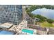 High-rise apartment with a rooftop pool overlooking a scenic lake and lush greenery at 150 E Robinson St # 801, Orlando, FL 32801