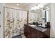 Elegant bathroom featuring a dark wood vanity with marble countertop and stylish lighting at 150 E Robinson St # 801, Orlando, FL 32801