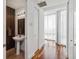 Modern powder room features a sleek vanity, wood accent wall, elegant mirror and natural light at 150 E Robinson St # 801, Orlando, FL 32801