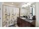 Elegant bathroom featuring a dark wood vanity with marble countertop and stylish lighting at 150 E Robinson St # 801, Orlando, FL 32801