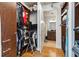 Walk-in closet leads into the bathroom with hardwood floors, built-in shelving and ample storage at 150 E Robinson St # 801, Orlando, FL 32801