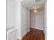 Hallway featuring hardwood floors, white trim and doors, and a stylish light fixture at 150 E Robinson St # 801, Orlando, FL 32801