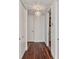 Hallway features sleek wood floors, modern light fixture, and doors leading to other rooms in the condo at 150 E Robinson St # 801, Orlando, FL 32801