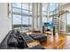 Elegant living room with expansive windows, stunning views, hardwood floors and a modern staircase at 150 E Robinson St # 801, Orlando, FL 32801