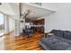 Open-concept living room with hardwood floors, modern furniture, and a stylish kitchen in the background at 150 E Robinson St # 801, Orlando, FL 32801