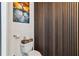 Chic powder room features stylish wood paneling, a toilet, and a charming decor at 150 E Robinson St # 801, Orlando, FL 32801