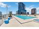 Beautiful rooftop pool area with modern lounge chairs and stunning views of the surrounding cityscape at 150 E Robinson St # 801, Orlando, FL 32801