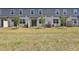 Townhome backyard featuring green grass, and a patio perfect for outdoor entertaining and relaxation at 16419 Bird Of Paradise Ave, Clermont, FL 34714