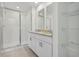 Bright bathroom with a glass shower, granite countertops, and white cabinets, offering a clean and modern aesthetic at 16419 Bird Of Paradise Ave, Clermont, FL 34714
