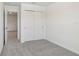 Bedroom with neutral walls, grey carpet and closet with sliding doors at 16419 Bird Of Paradise Ave, Clermont, FL 34714