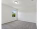Bedroom featuring neutral walls, plush gray carpeting and a window view at 16419 Bird Of Paradise Ave, Clermont, FL 34714