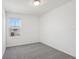 Bright bedroom featuring plush gray carpeting and a window view at 16419 Bird Of Paradise Ave, Clermont, FL 34714