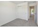 Cozy bedroom featuring neutral walls, plush carpet, and a closet at 16419 Bird Of Paradise Ave, Clermont, FL 34714