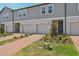 Charming townhome with manicured lawn and brick walkway leading to the front door at 16419 Bird Of Paradise Ave, Clermont, FL 34714