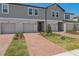 Charming townhome with well manicured lawn, brick walkway leading to front door and one car garage at 16419 Bird Of Paradise Ave, Clermont, FL 34714