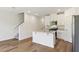 Modern kitchen features an island, stainless steel appliances, and white cabinets at 16419 Bird Of Paradise Ave, Clermont, FL 34714