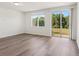 Bright open living room with wood flooring and sliding glass door access to patio at 16419 Bird Of Paradise Ave, Clermont, FL 34714
