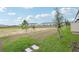 View of backyard with grass and small trees at 16430 Bird Of Paradise Ave, Clermont, FL 34714