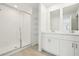 A spacious bathroom with a glass shower and large double sink at 16430 Bird Of Paradise Ave, Clermont, FL 34714