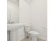 Clean bathroom with pedestal sink and toilet on tile flooring at 16430 Bird Of Paradise Ave, Clermont, FL 34714