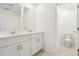 Bright bathroom featuring double sinks with white cabinets and a separate toilet room at 16430 Bird Of Paradise Ave, Clermont, FL 34714