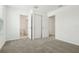 Bedroom with plush carpeting, closet, and view of ensuite bath at 16430 Bird Of Paradise Ave, Clermont, FL 34714