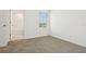 This bedroom features carpet flooring and a view to the outside at 16430 Bird Of Paradise Ave, Clermont, FL 34714