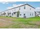 Exterior view of the back of the townhome with sodded yard at 16430 Bird Of Paradise Ave, Clermont, FL 34714
