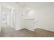 Upstairs hallway featuring neutral carpeting leading to various doorways at 16430 Bird Of Paradise Ave, Clermont, FL 34714