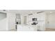 Bright kitchen boasts stainless steel appliances, island with sink, and modern white cabinetry at 16430 Bird Of Paradise Ave, Clermont, FL 34714