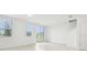 Bright, spacious living area with large windows, tiled flooring, and sliding glass door at 16430 Bird Of Paradise Ave, Clermont, FL 34714